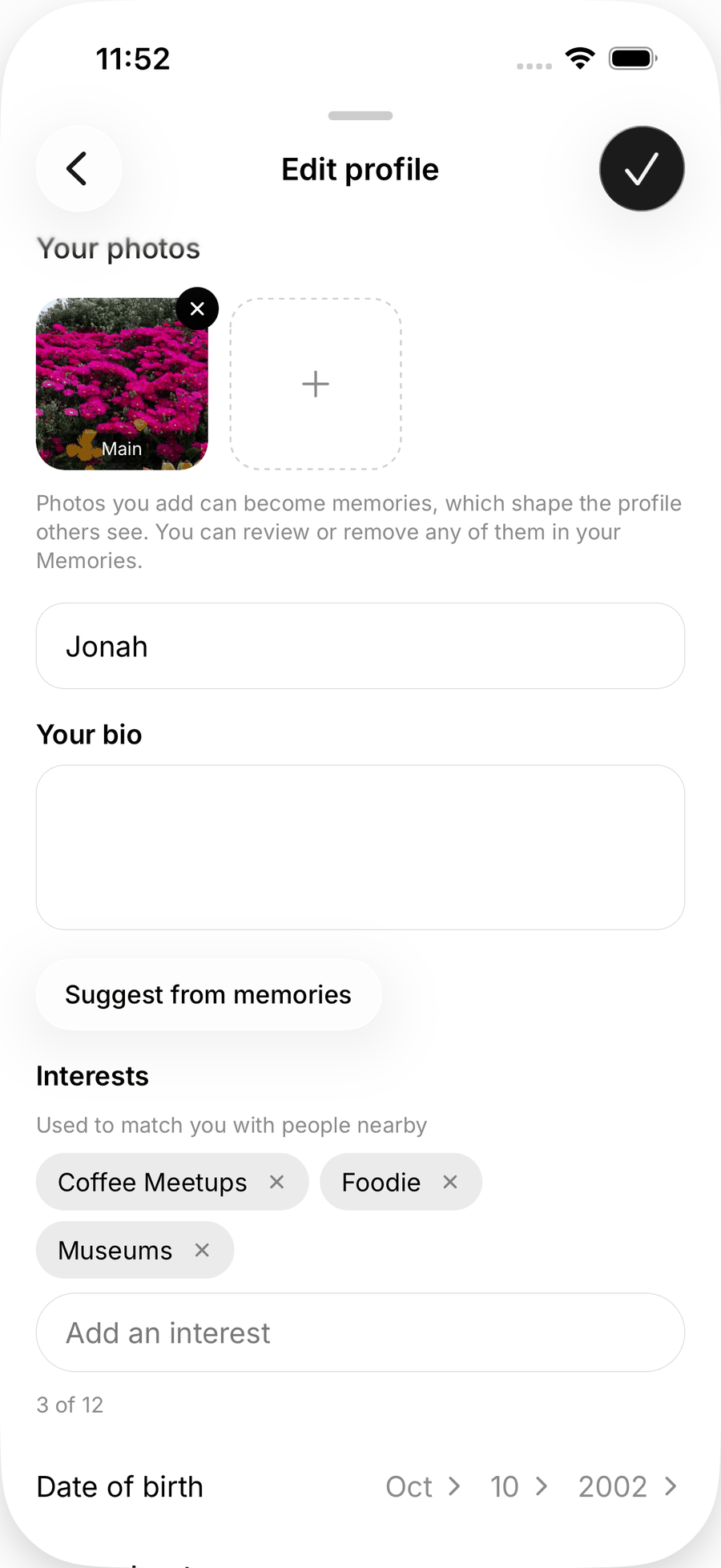 The top of Edit profile on iOS with Your photos, the name field, an empty bio, a Suggest from memories button and interest chips